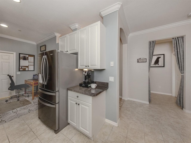 kitchen featuring crown molding, stainless steel fridge with ice dispenser, light tile patterned floors, and white cabinets