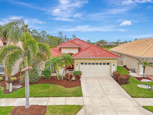 mediterranean / spanish house featuring a garage and a front yard