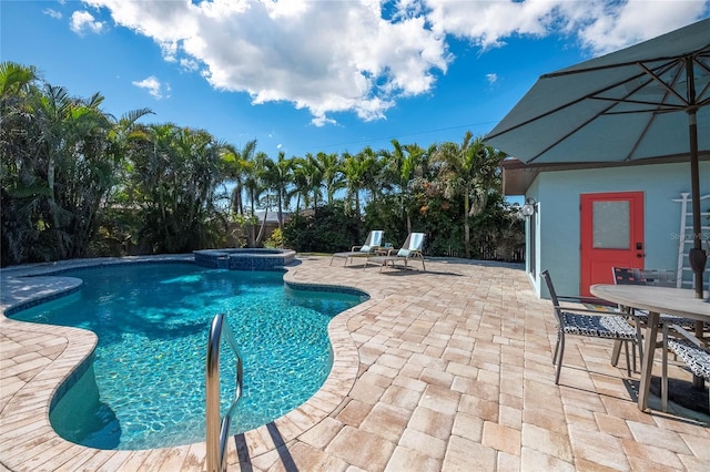 view of swimming pool featuring a patio and an in ground hot tub