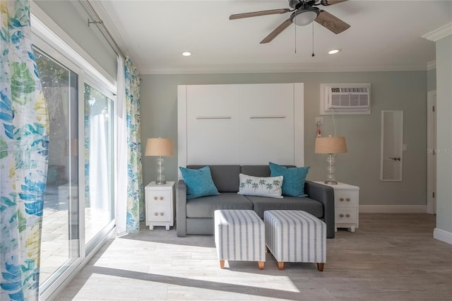 living room featuring ceiling fan, ornamental molding, light hardwood / wood-style flooring, and an AC wall unit