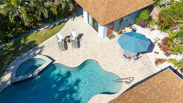 view of swimming pool with a patio area and an in ground hot tub