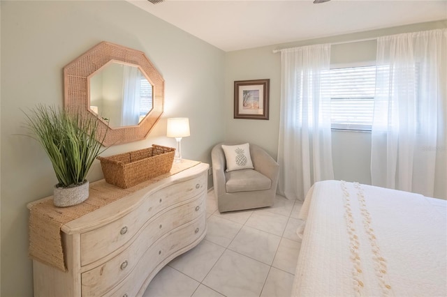 bedroom with light tile patterned floors