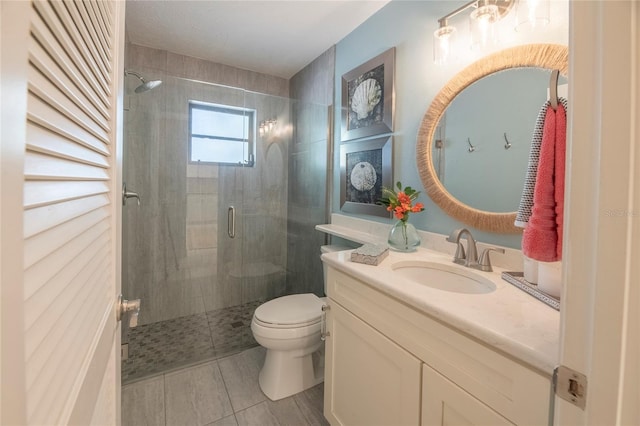 bathroom featuring vanity, toilet, tile patterned flooring, and a shower with door