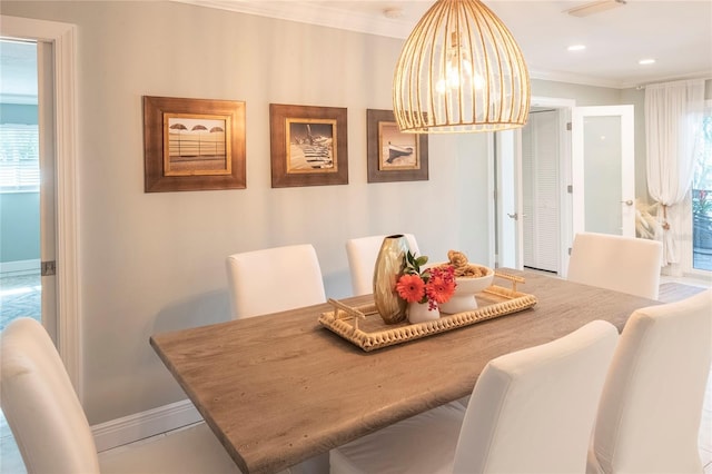 dining area featuring a notable chandelier and crown molding