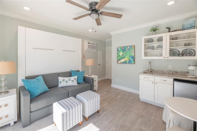 living room with a wall mounted air conditioner, indoor wet bar, light hardwood / wood-style flooring, ornamental molding, and ceiling fan