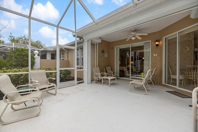 unfurnished sunroom featuring ceiling fan