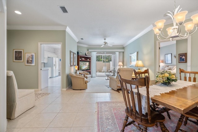 dining space with light tile patterned floors, baseboards, visible vents, crown molding, and ceiling fan with notable chandelier