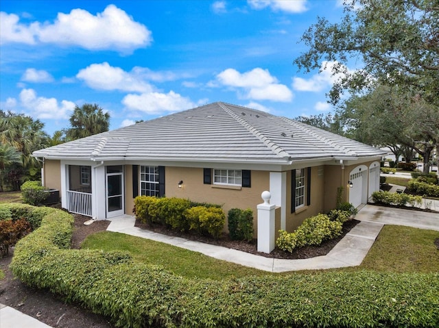 view of front of home featuring a garage and a front lawn