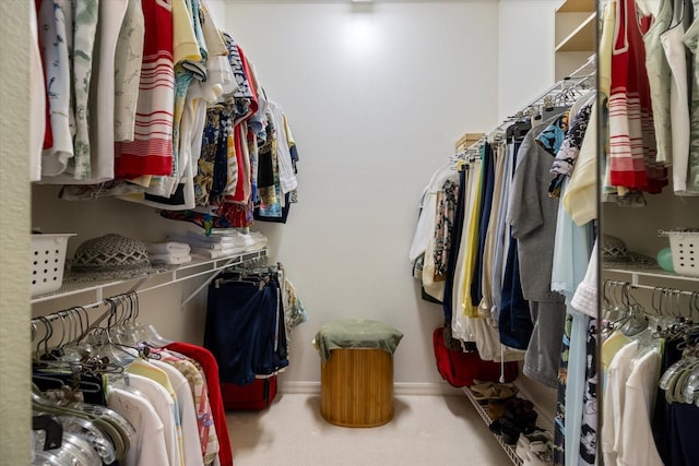 walk in closet featuring carpet