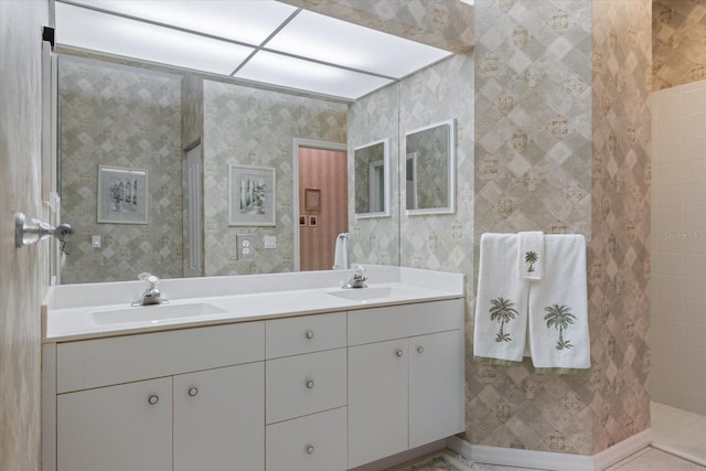 full bathroom with a sink and wallpapered walls