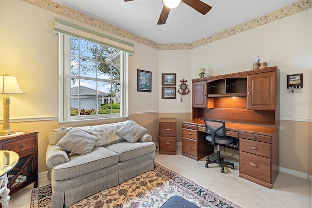 office featuring light tile patterned floors, ceiling fan, and baseboards