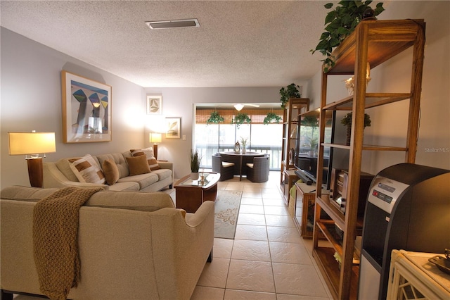 tiled living room featuring a textured ceiling