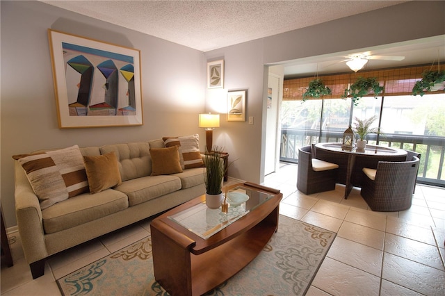 tiled living room featuring ceiling fan and a textured ceiling