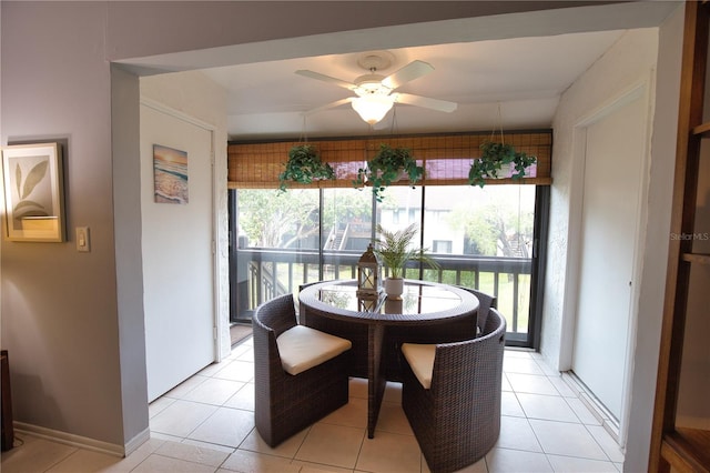 tiled dining area featuring ceiling fan