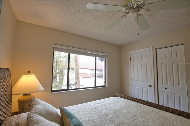 bedroom with a textured ceiling and ceiling fan