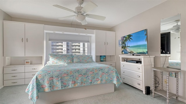 bedroom featuring light carpet and ceiling fan