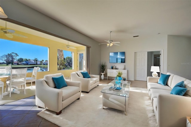 tiled living room featuring ceiling fan