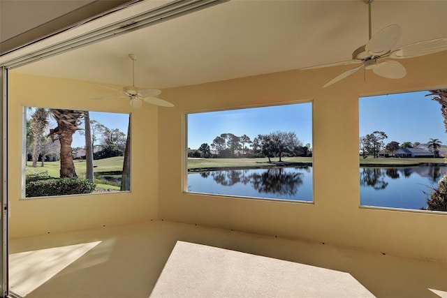 interior space featuring ceiling fan and a water view