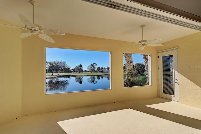 view of patio featuring ceiling fan and a water view