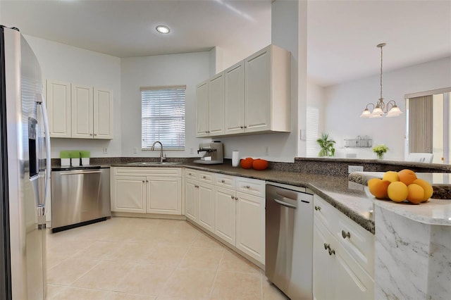 kitchen with sink, stainless steel appliances, and white cabinetry