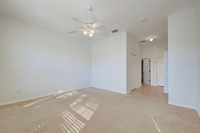 empty room featuring ceiling fan and light colored carpet