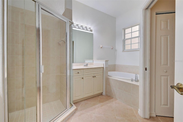 bathroom with shower with separate bathtub, vanity, and tile patterned flooring