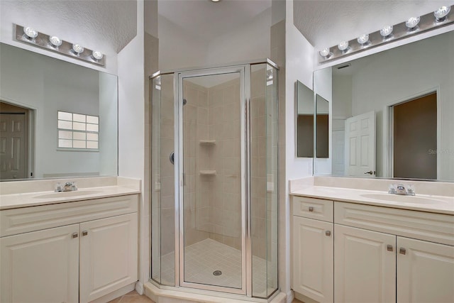 bathroom featuring a shower with shower door, tile patterned floors, and vanity