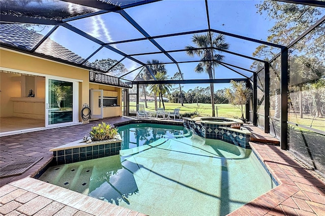 view of pool featuring an in ground hot tub, a patio area, and glass enclosure