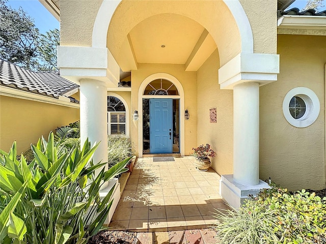 view of exterior entry featuring a patio area