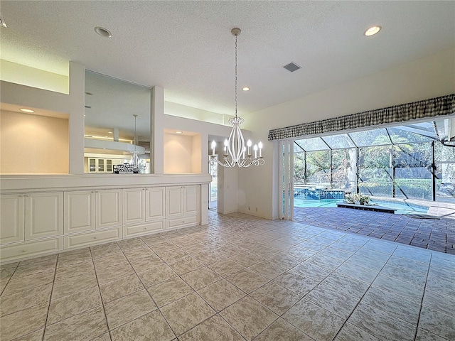 unfurnished dining area with a textured ceiling