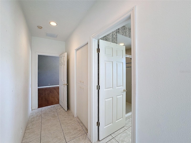 hallway with light tile patterned floors