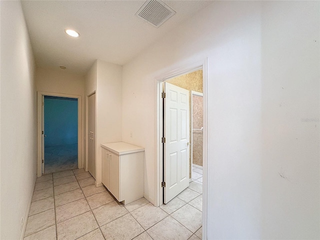 corridor with light tile patterned floors