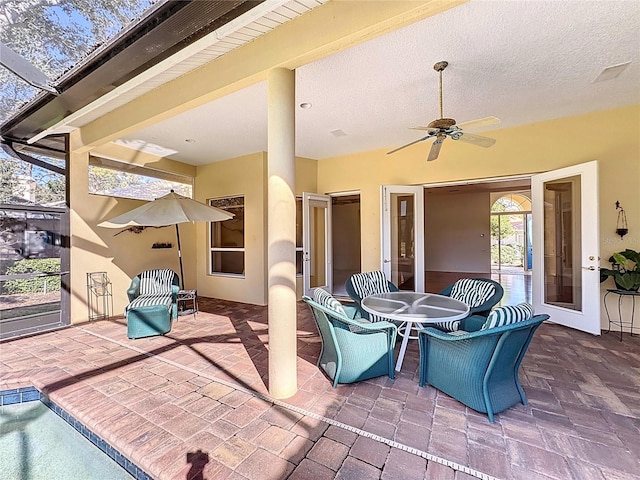 view of patio / terrace with a pool and ceiling fan