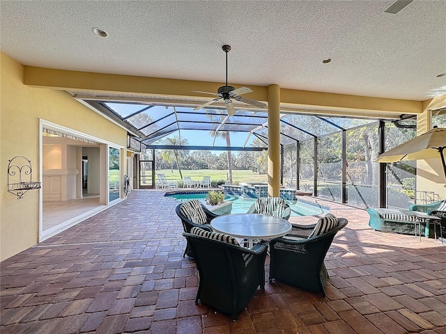 view of patio with a lanai and a jacuzzi