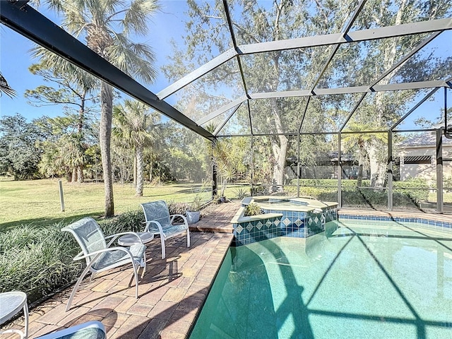 view of pool with a lawn, a patio, glass enclosure, and an in ground hot tub