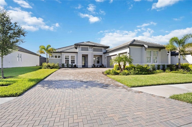 view of front of house with a garage and a front yard