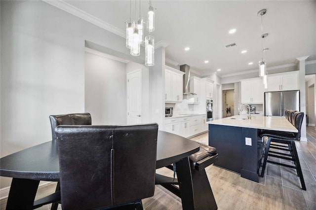 dining area with sink and ornamental molding