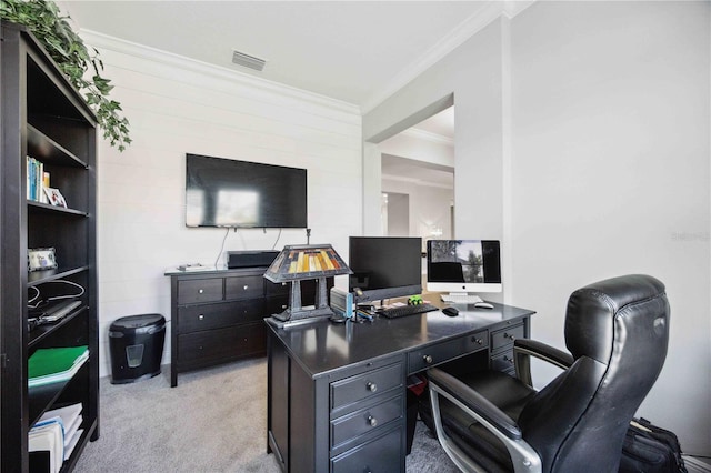 carpeted home office featuring crown molding