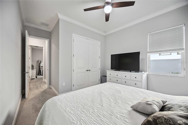 bedroom with crown molding, ceiling fan, light colored carpet, and a closet