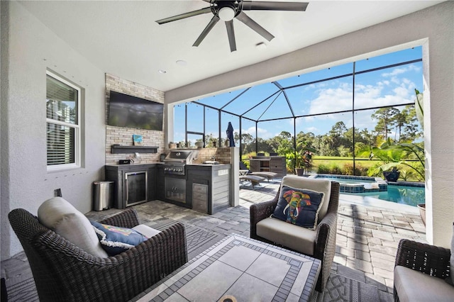 view of patio with a grill, ceiling fan, and exterior kitchen