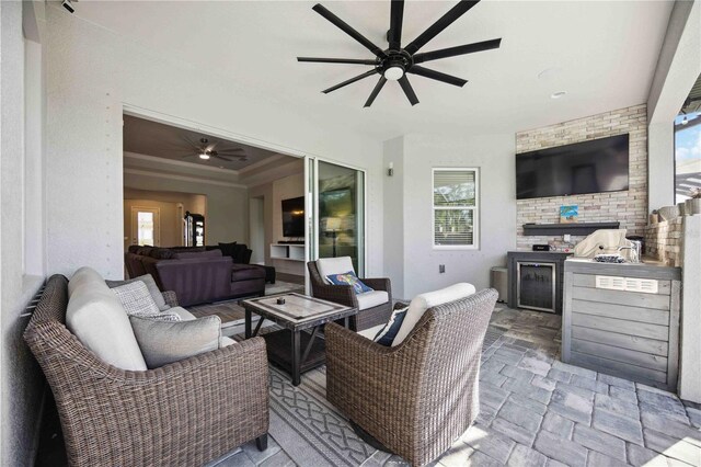 view of patio / terrace with ceiling fan, an outdoor hangout area, and exterior kitchen