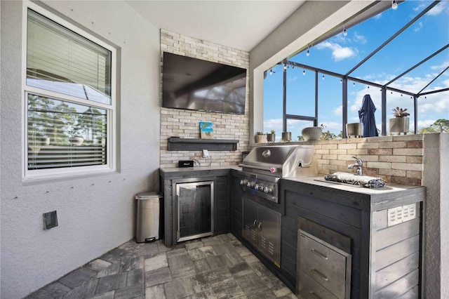 view of patio / terrace featuring an outdoor kitchen, area for grilling, and glass enclosure