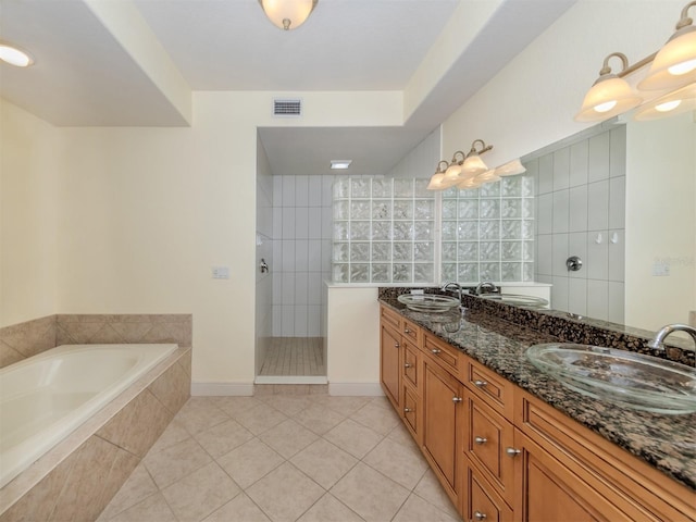 bathroom featuring tile patterned flooring, vanity, and independent shower and bath