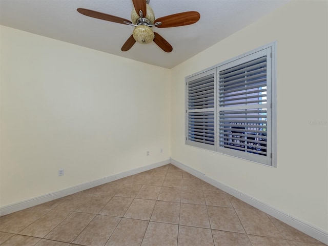 empty room featuring light tile patterned floors and ceiling fan