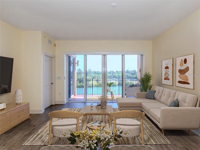 living room with a water view and dark hardwood / wood-style floors