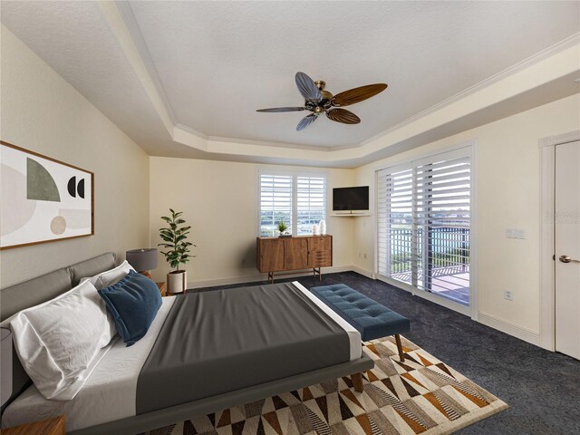 carpeted bedroom with crown molding, ceiling fan, a tray ceiling, and access to exterior