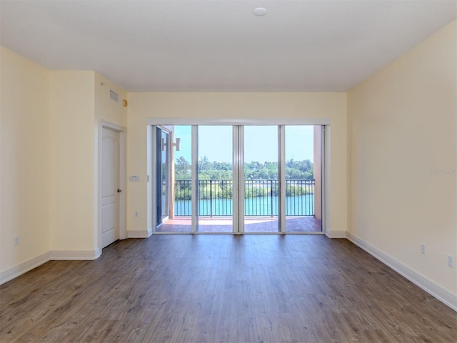 unfurnished room with dark hardwood / wood-style floors