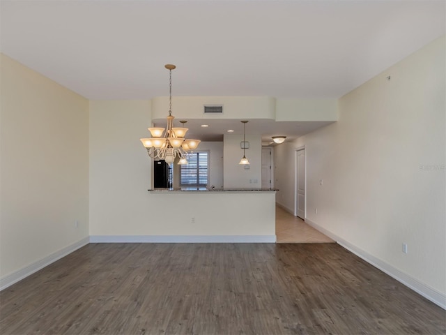 interior space with hardwood / wood-style flooring and a chandelier