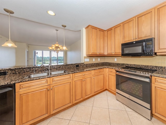 kitchen with pendant lighting, sink, black appliances, vaulted ceiling, and dark stone counters