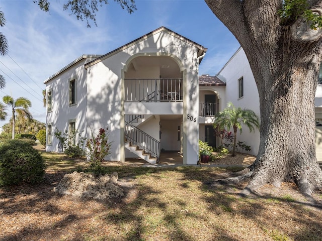 back of house featuring a balcony